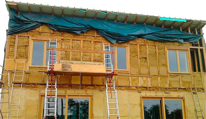 Casa portante de dos plantas que se está construyendo con paja y cemento