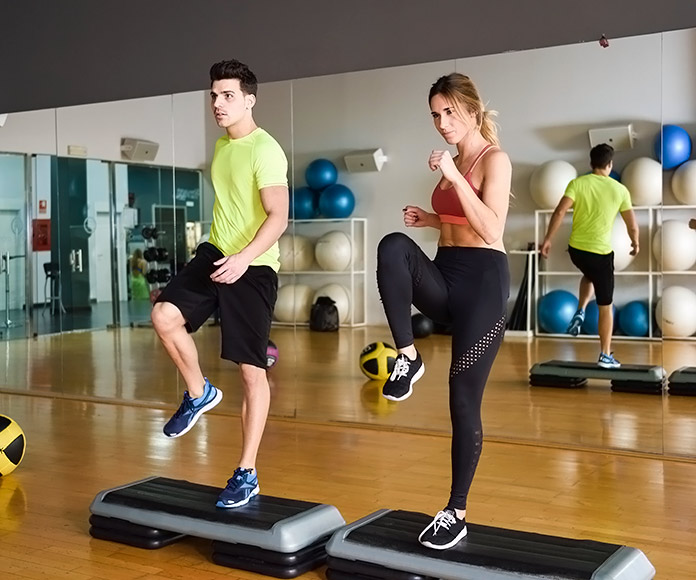 entrenador y alumna entrenando en un gimnasio