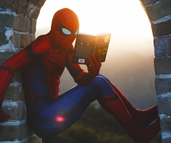 Spiderman leyendo un libro.