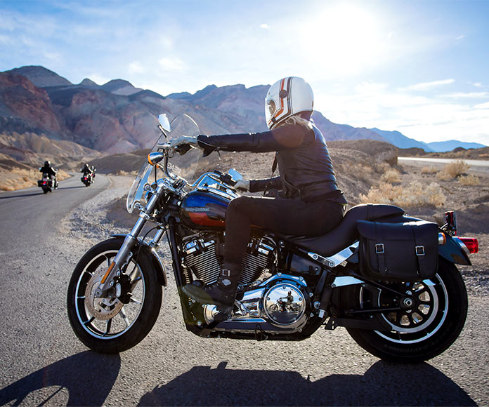 Motoristas con Harley Davidson por carretera