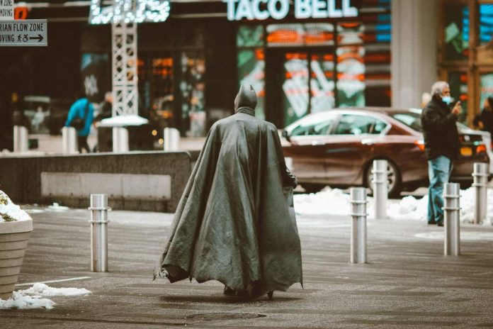 Una persona caminando con traje de superhéroe en la ciudad.