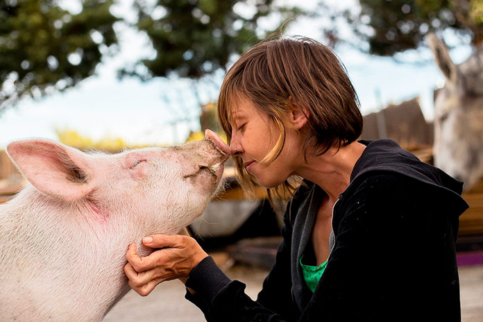 Laura Luengo, fundadora del Santuario Wings of Heart, fotografiada con un cerdito