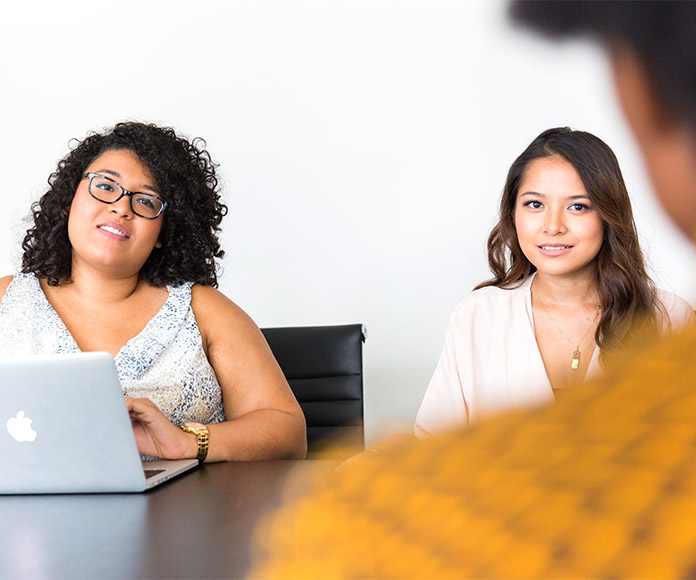 Tres personas en una reunión de trabajo